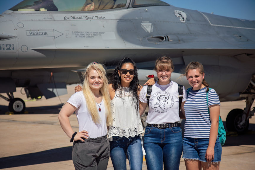 Group of students in front of an airplane