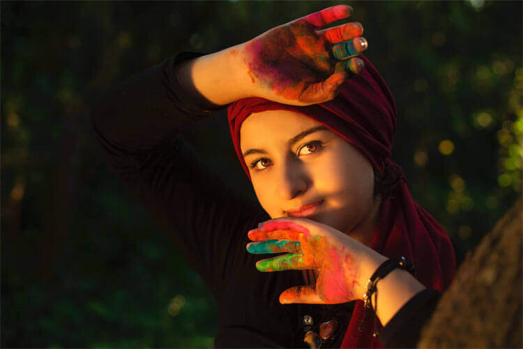 Woman with colorful paint on her hands