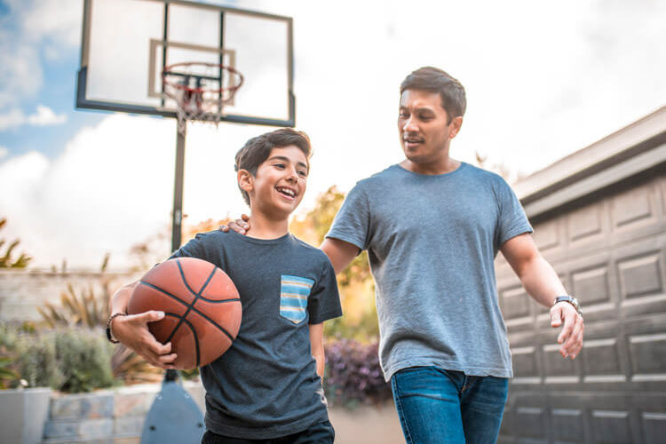 Father with son playing basketball